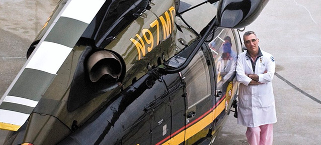 Dr. Thomas Scalea standing next to Shock Trauma helicopter
