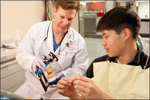 UHC Dentist consults with student