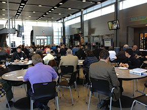 Attendees sitting at tables listening to speaker at the Kansas Regional Independent Inventors Conference.